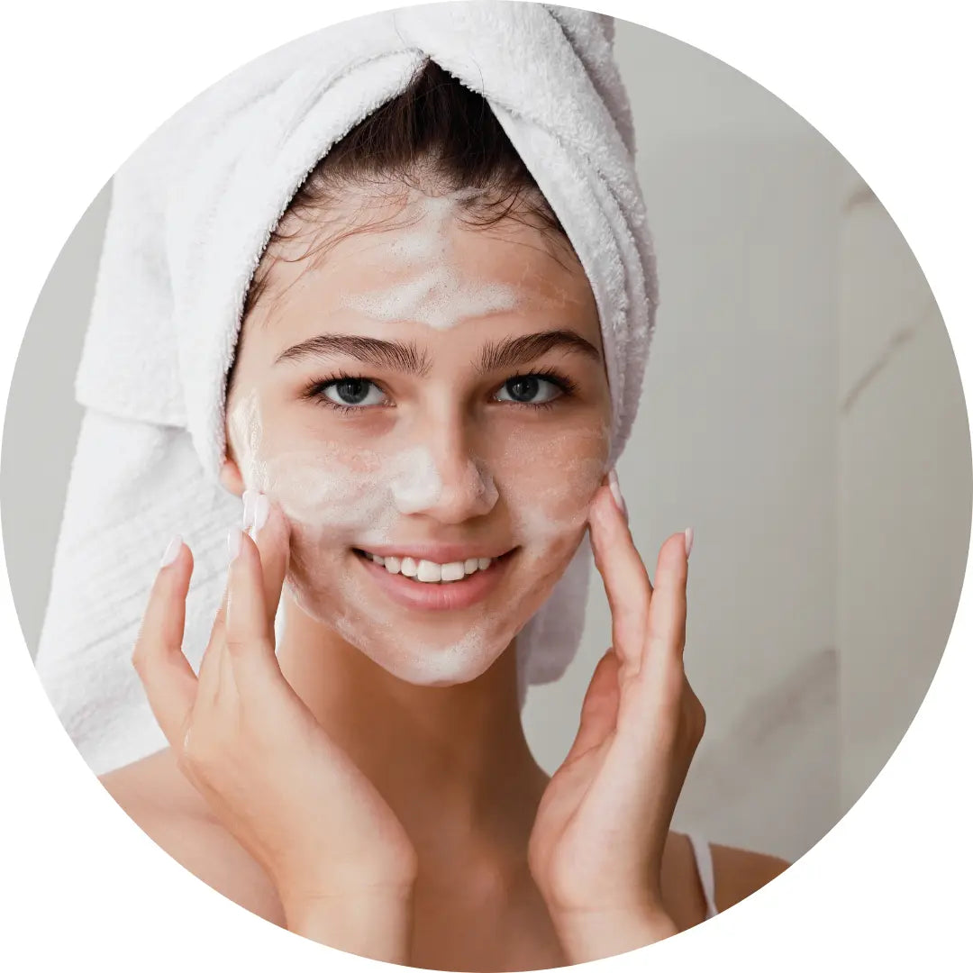 Youthful woman using an own branded facial wash
