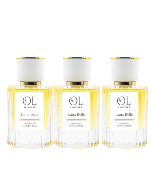 Three bottles of Luna Belle perfume on a white background