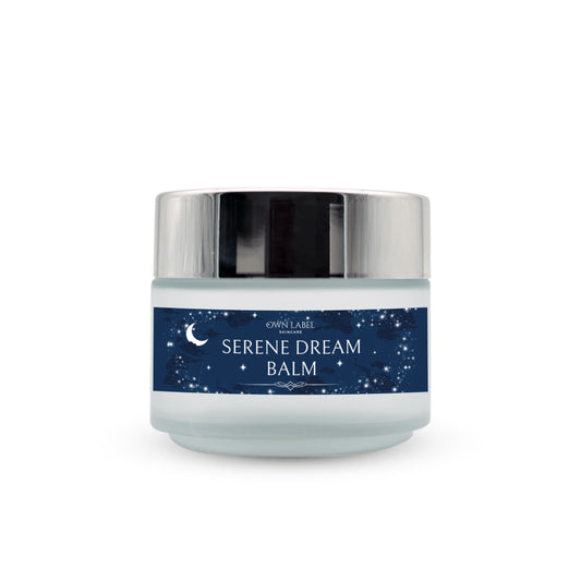 Own Label Serene Dream Balm in a frosted glass jar with a reflective silver lid and a navy blue label decorated with white stars and a crescent moon.