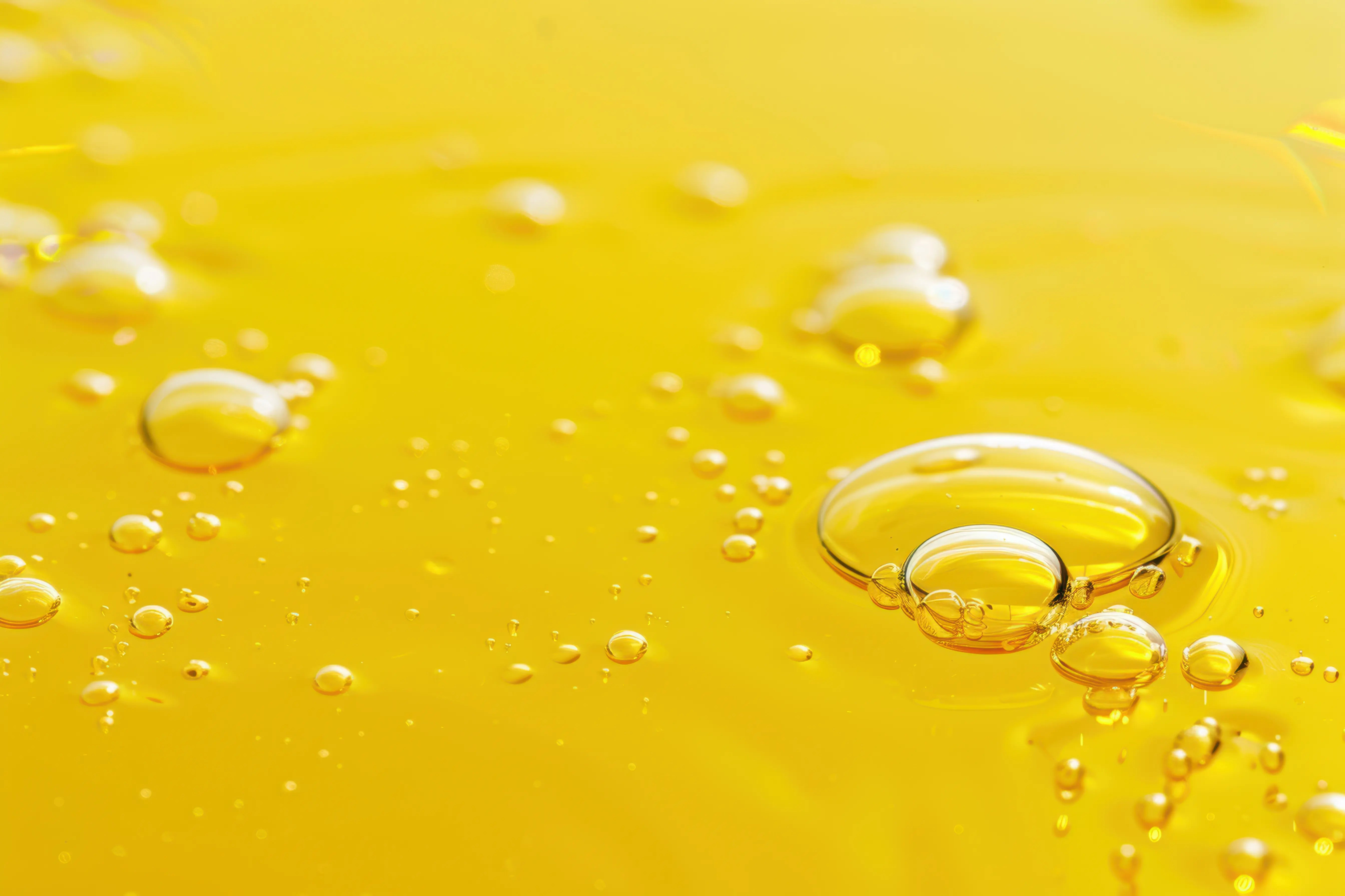 Vitamin E OIl Bubbles on a yellow background