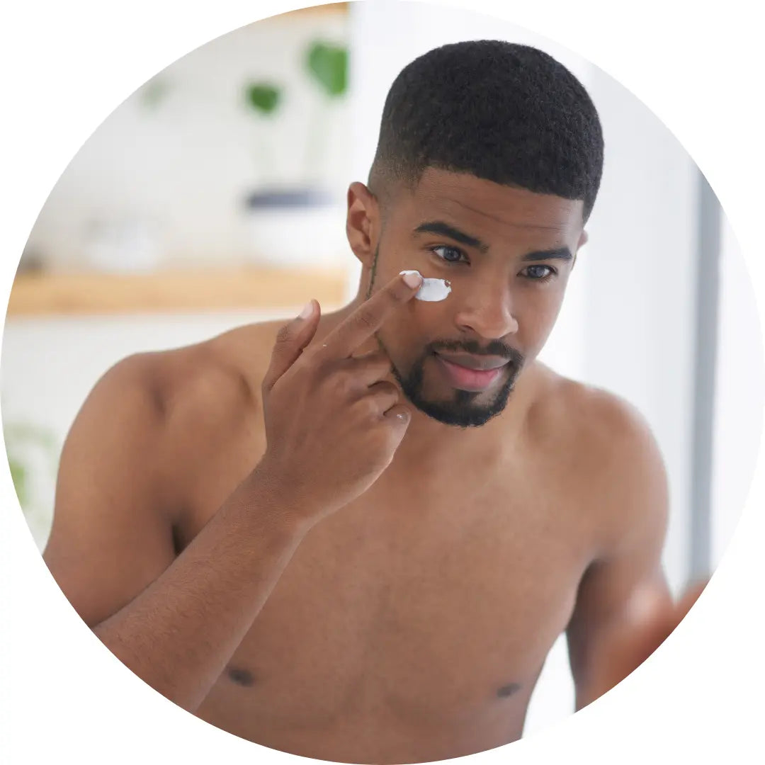 black man applying face cream 