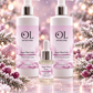 Three OL Skincare products in a coordinated holiday-themed setting: two large pump bottles labeled Sugar Plum Fairy Hand & Body Wash and one smaller dropper bottle labeled cuticle Oil, arranged with pink floral and snowy decorative elements on a reflective surface.