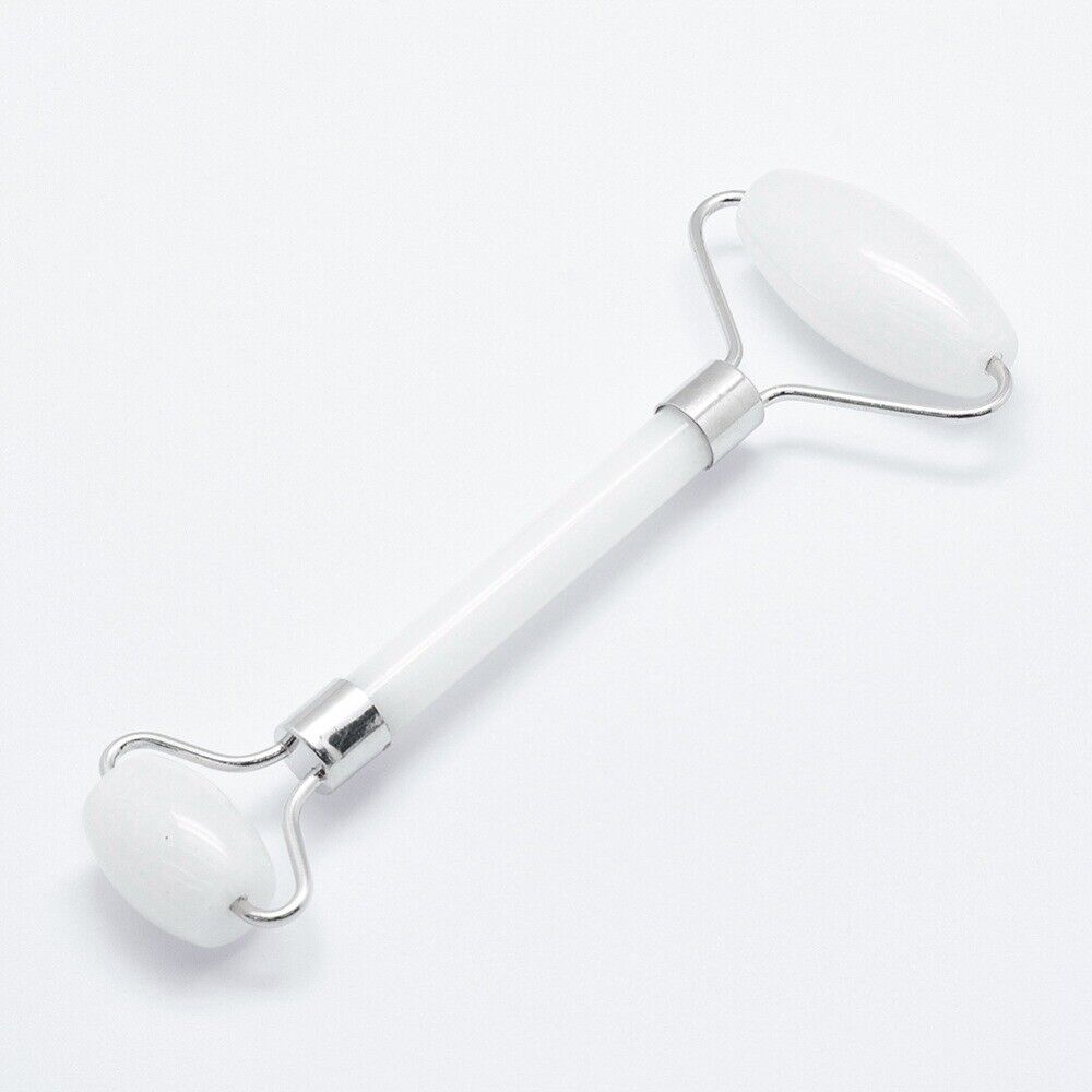 "White and Chrome Facial Roller on a White Background: A sleek and elegant facial roller made of white and chrome materials, resting on a pristine white backdrop. Its smooth surface and metallic accents exude a sense of luxury and sophistication. The roller's compact design and ergonomic handle make it easy to use, providing a refreshing and revitalizing experience for your skin."