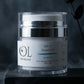 OL Skincare Derma-Veil SPF 50 Face Cream in a clear jar with a silver lid, displayed on a dark stone pedestal with a smoky background and a dark rose stem.