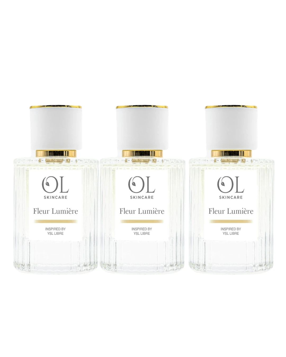 Three bottles of OL Skincare Fleur Lumére perfume on a white background