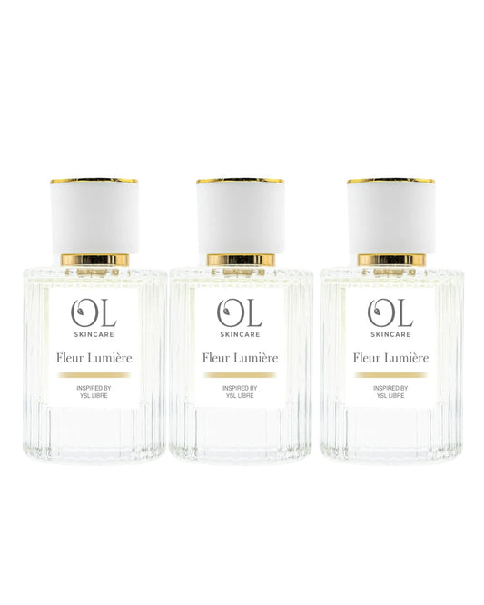 Three bottles of OL Skincare Fleur Lumére perfume on a white background