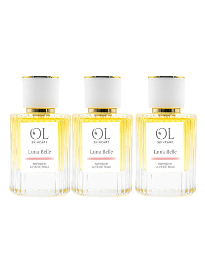 Three bottles of Luna Belle perfume  on a white background