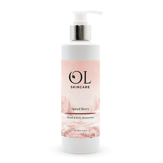 A white pump bottle of OL Skincare Spiced Berry Hand & Body Moisturizer with a silver pump collar and a pink label, set against a plain white background.