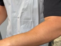 spf 50 being applied to a dark skin arm